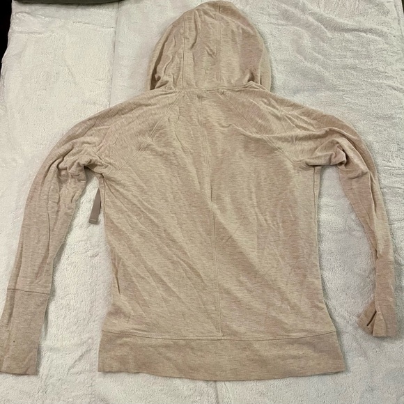 Athleta Beige Wrap Hoodie -Size L
Hole on the right sleeve by the cuff. 
Used - Picture 9 of 9